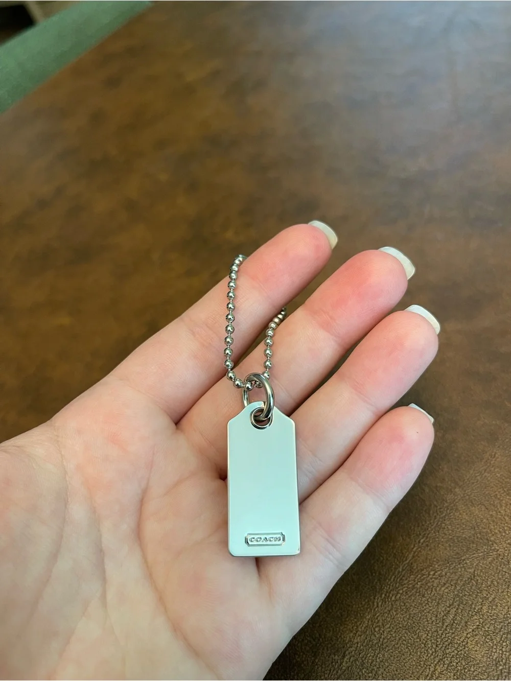 Coach silver metal hangtag